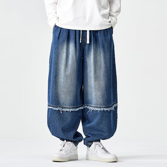 Herren Weit geschnittene Baggy-Denim-Hose mit Tunnelzug, elastischen Beinabschlüssen und Fransen-Detail Shop Nory