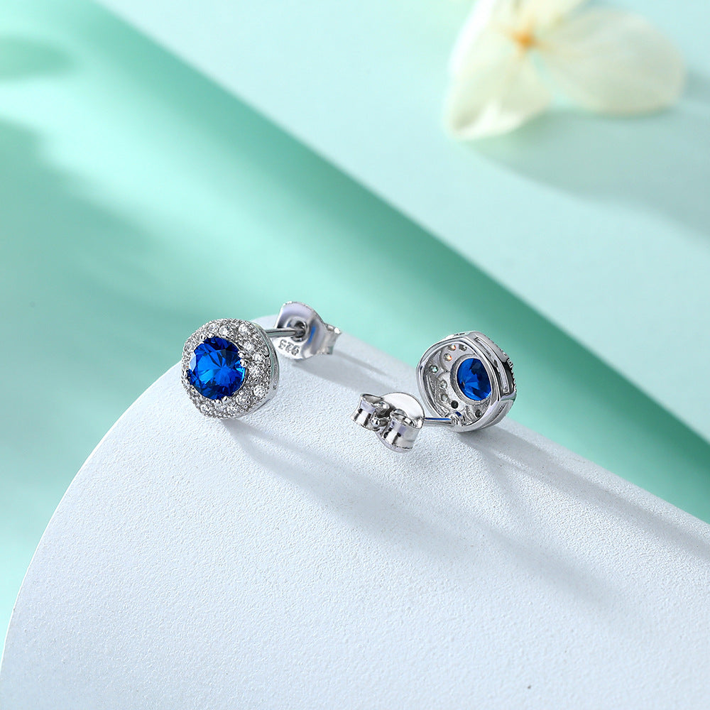 Damen Ohrstecker mit strahlendem blauen Hauptstein und kunstvollen Zirkonia-Details Shop Nory