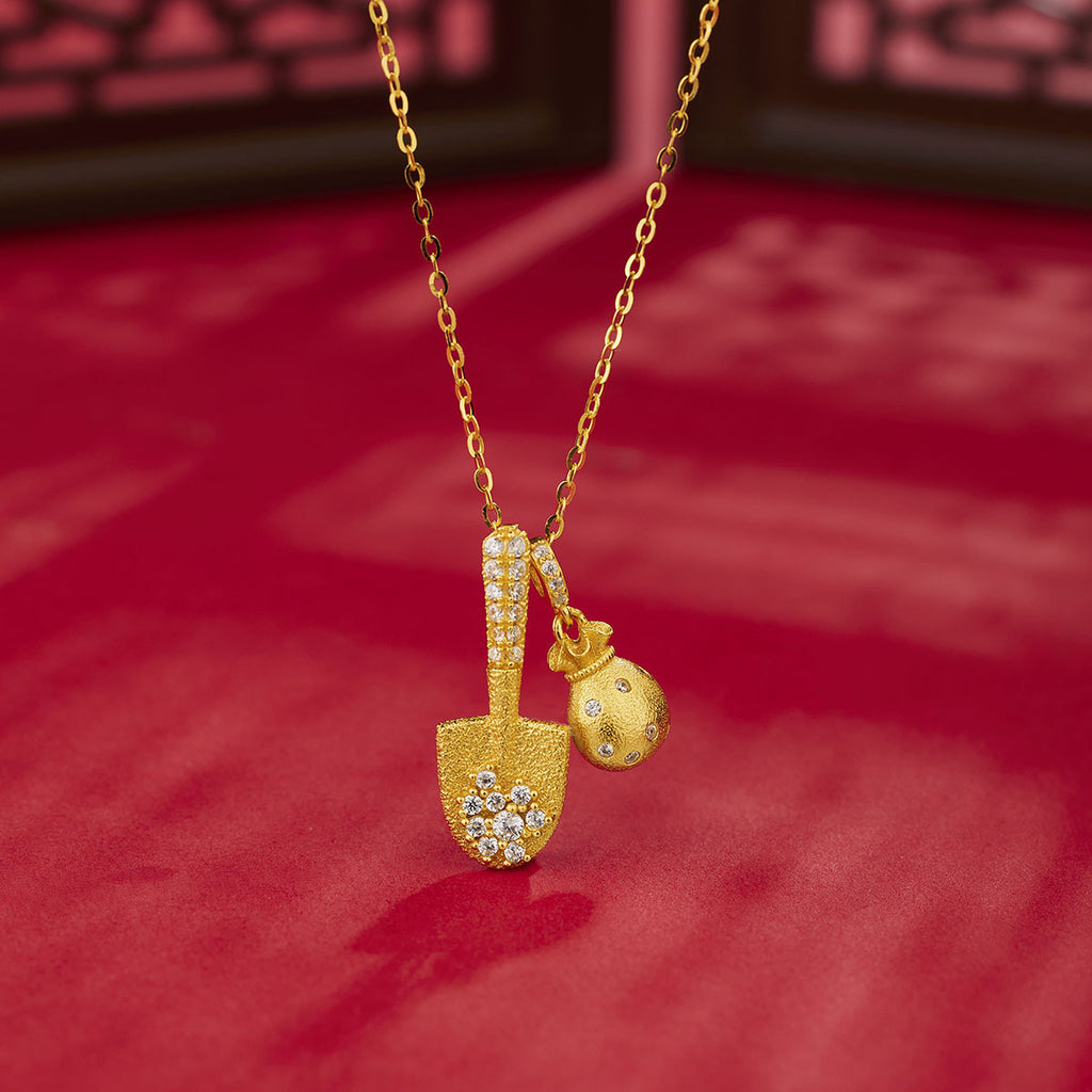 Damen Halskette mit goldfarbenem Schaufel- und Geldbeutel-Anhänger und funkelnden Kristallen Shop Nory