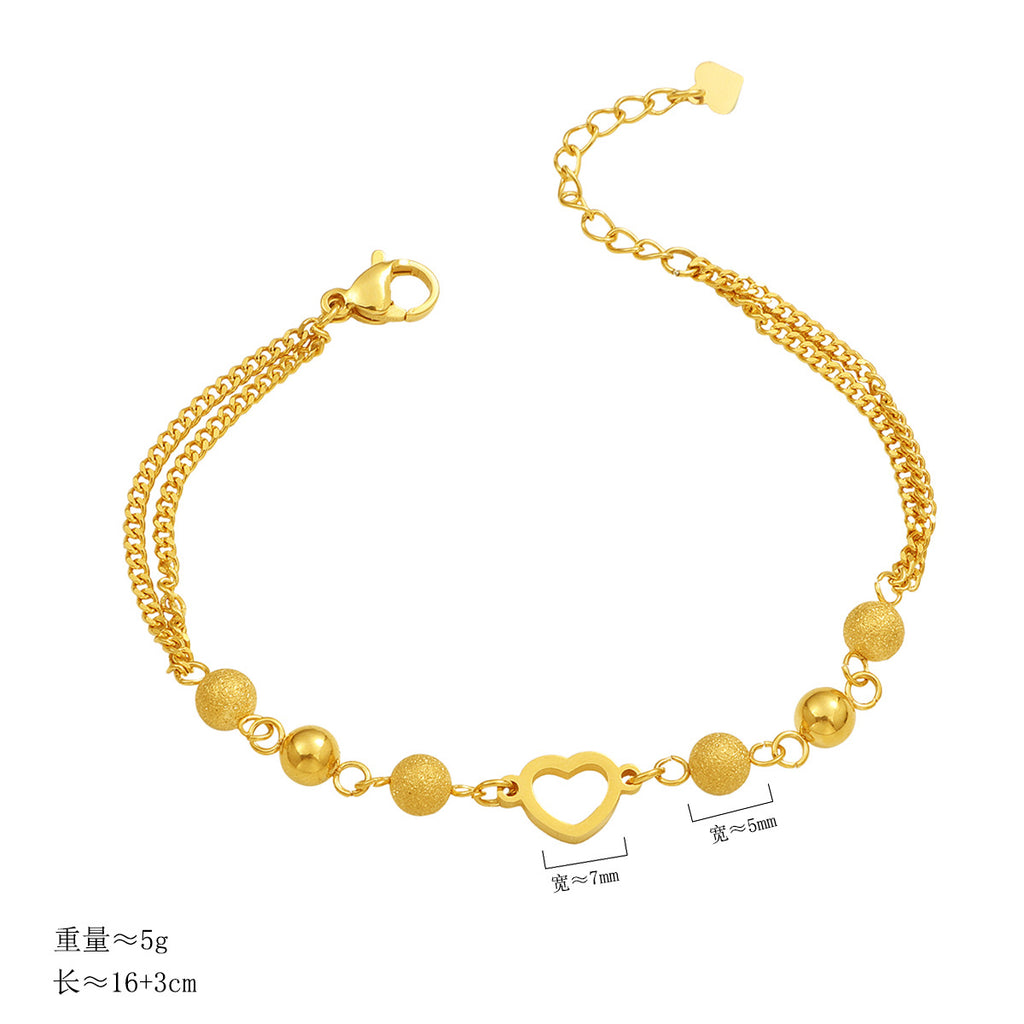 Damen modisches Armband mit funkelnden Kugeldetails und Herzanhänger Shop Nory