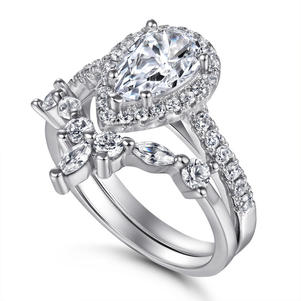 Damen eleganter Ring mit tropfenförmigem Hauptstein und funkelndem Zirkonia-Besatz Shop Nory