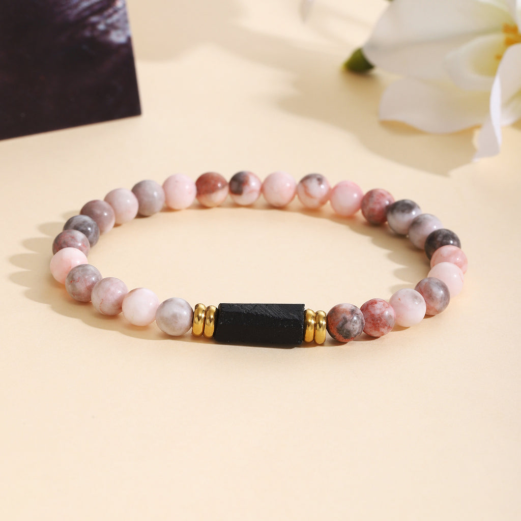 Damenarmband aus Rosenquarz mit schwarzem Akzent und goldenen Verzierungen Shop Nory