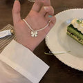 Damen Halskette mit elegantem Perlenband und filigranem Schleifenanhänger Shop Nory