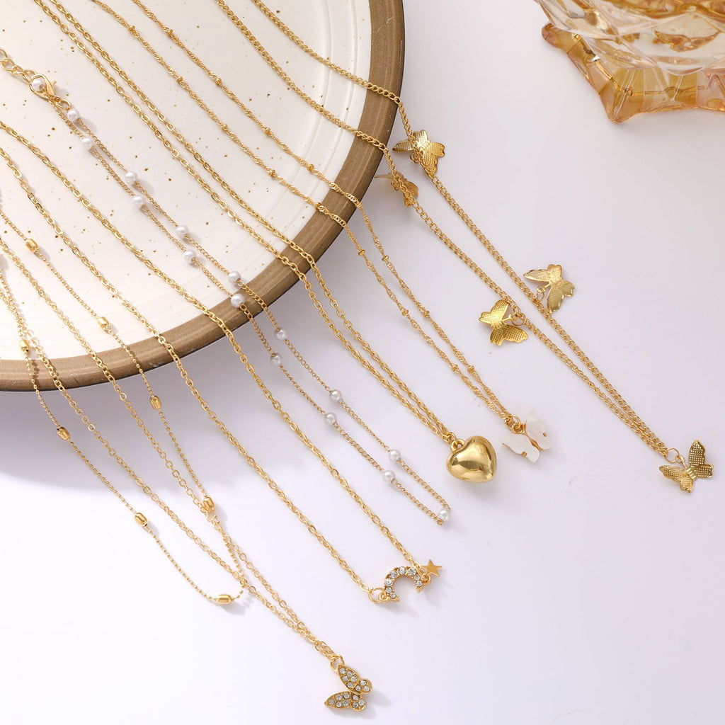Damen Halskette Set aus feinen goldenen Ketten mit verspielten Anhängern Shop Nory