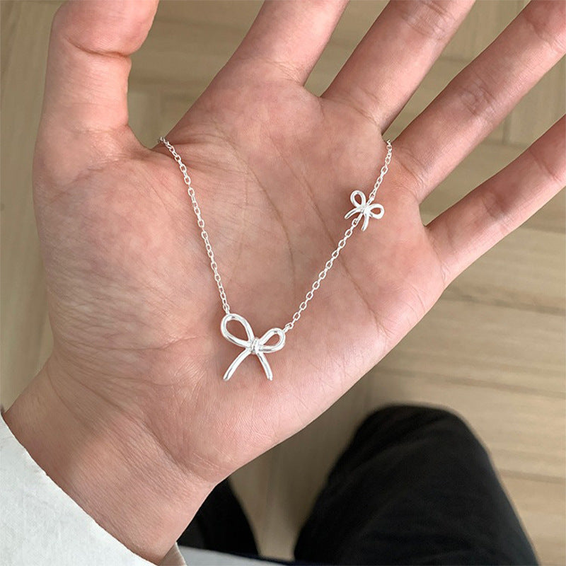 Damen Silberne Halskette mit stilvollem Schleifen-Design Shop Nory
