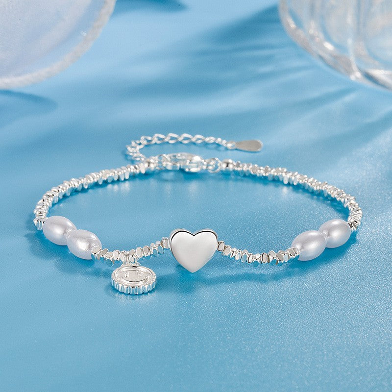 Damen Armband aus edlen Perlen mit herzförmigem Anhänger und funkelndem Element Shop Nory