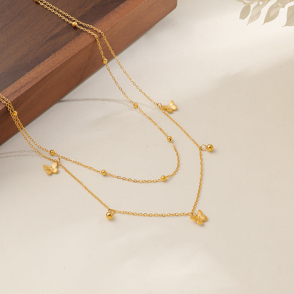 Damen mehrlagige Halskette mit filigranen Schmetterlings- und Kugeldetails Shop Nory