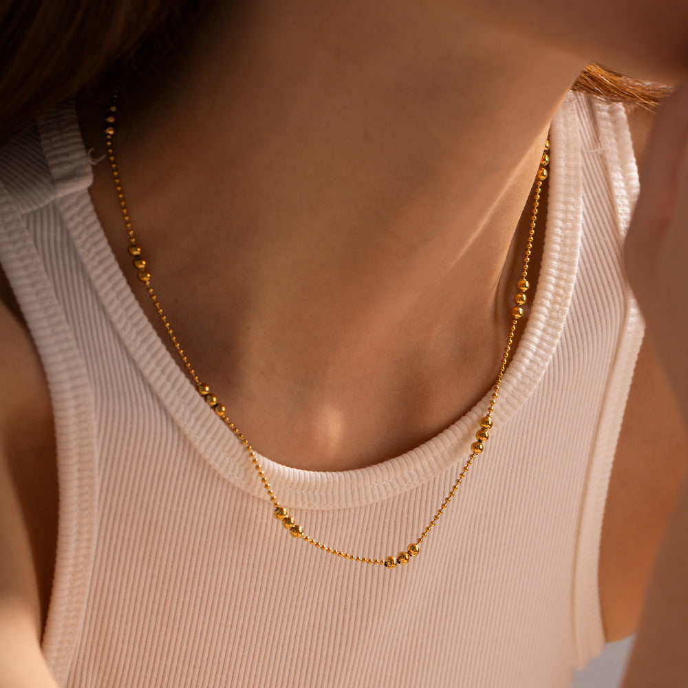 Damen Halskette mit schimmernden goldenen Kugeldetails Shop Nory