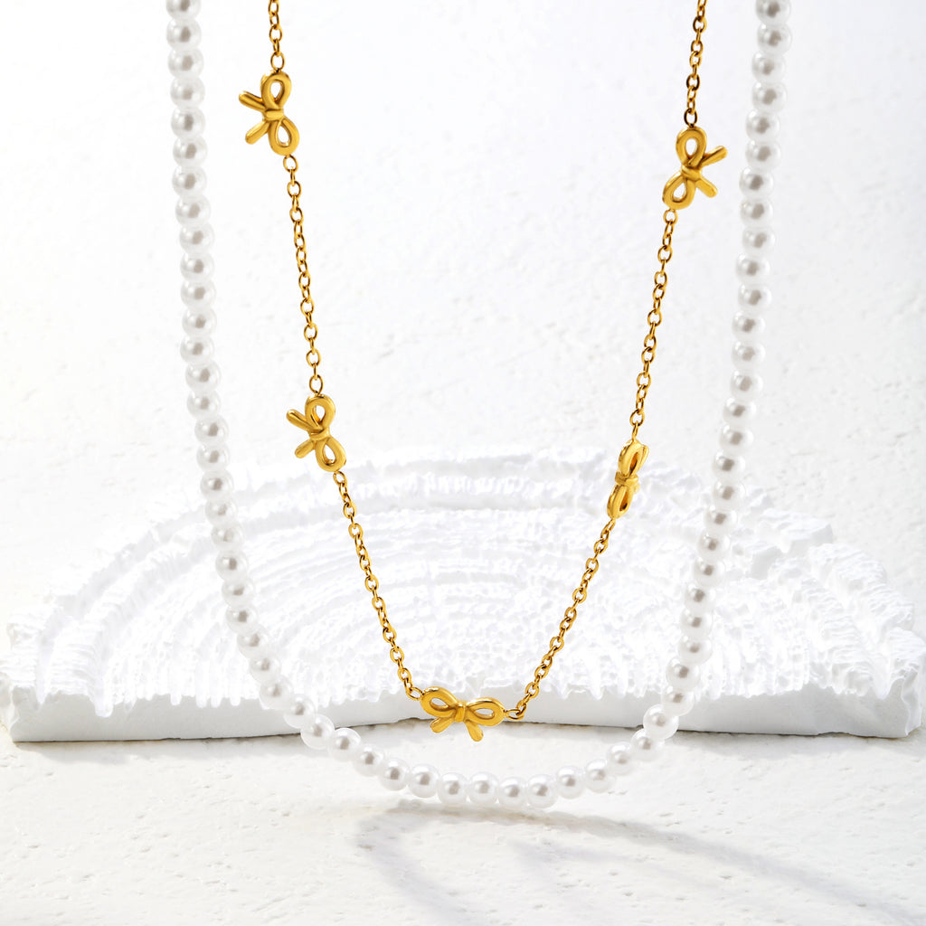 Damen mehrlagige Halskette mit zarten Perlen und eleganten Schleifenanhängern Shop Nory