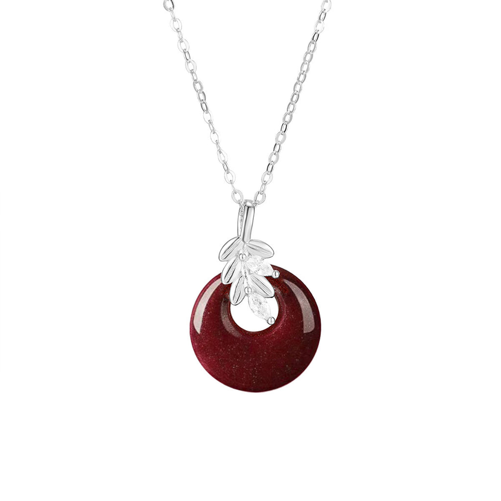 Damen Halskette mit kunstvollem runden Anhänger aus rotem Halbedelstein und goldenen Blätterdetails Shop Nory