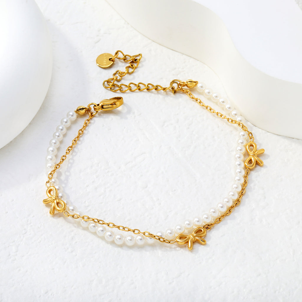Damen zarte Perlenarmband mit eleganten Schleifenanhängern Shop Nory