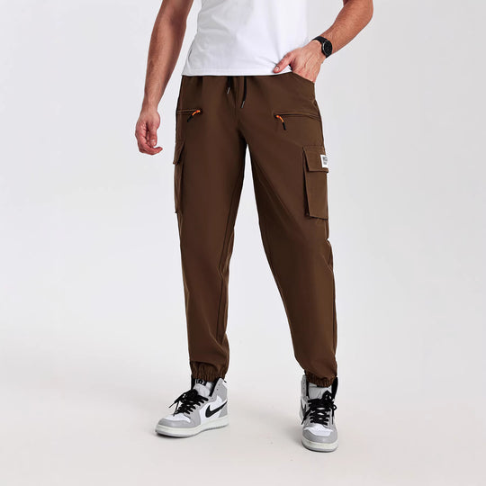 Herren konisch geschnittene Utility-Cargohose im Joggerstil mit Tunnelzugbund, Reißverschlusstaschen & elastischen Beinabschlüssen Shop Nory