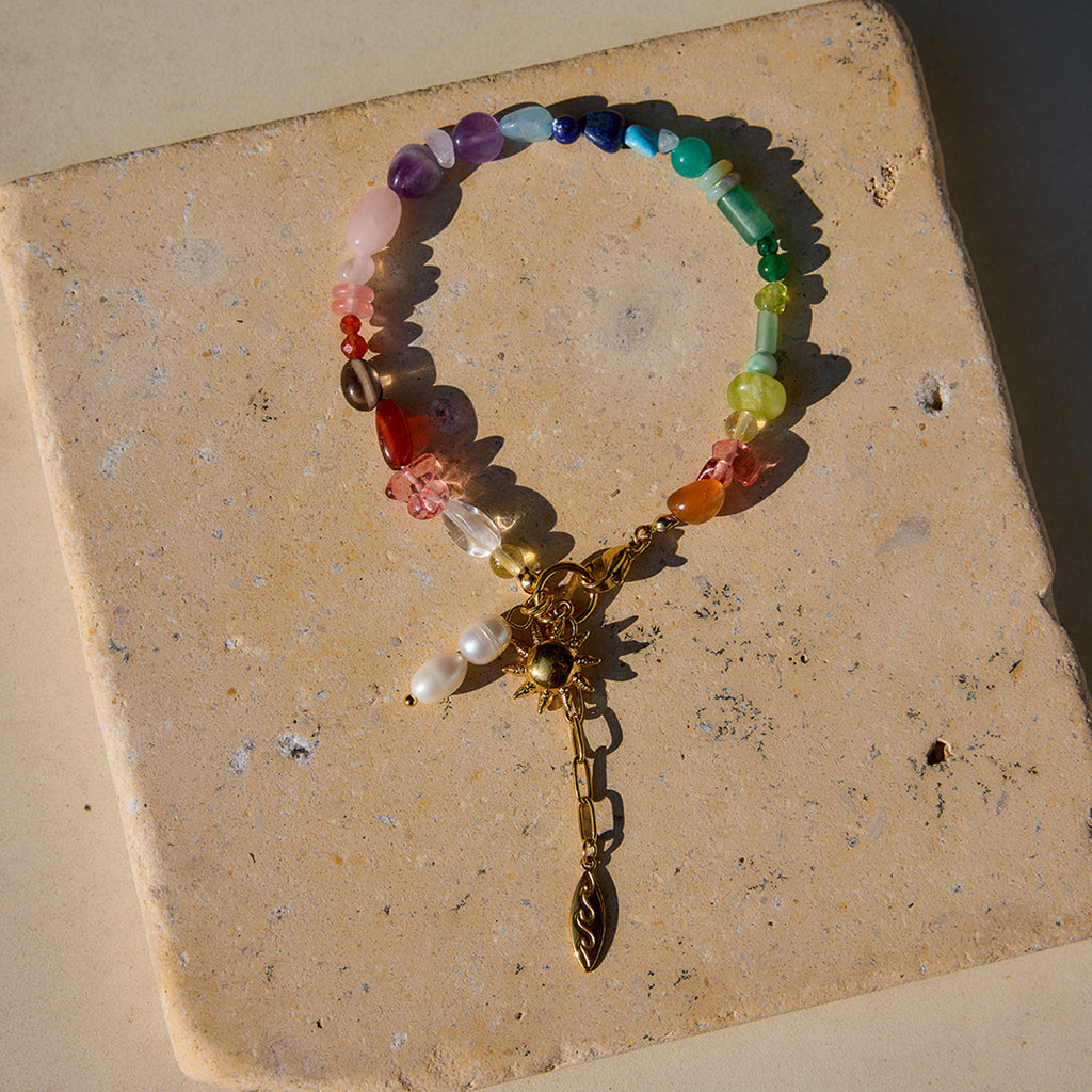 Damen Armband mit bunten Edelstein-Akzenten und goldfarbenem Sonnensymbol Shop Nory