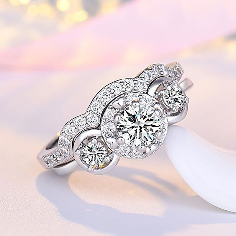 Damen Verlobungsring mit kunstvollem Zirkonia-Besatz und eleganter Wellenstruktur Shop Nory
