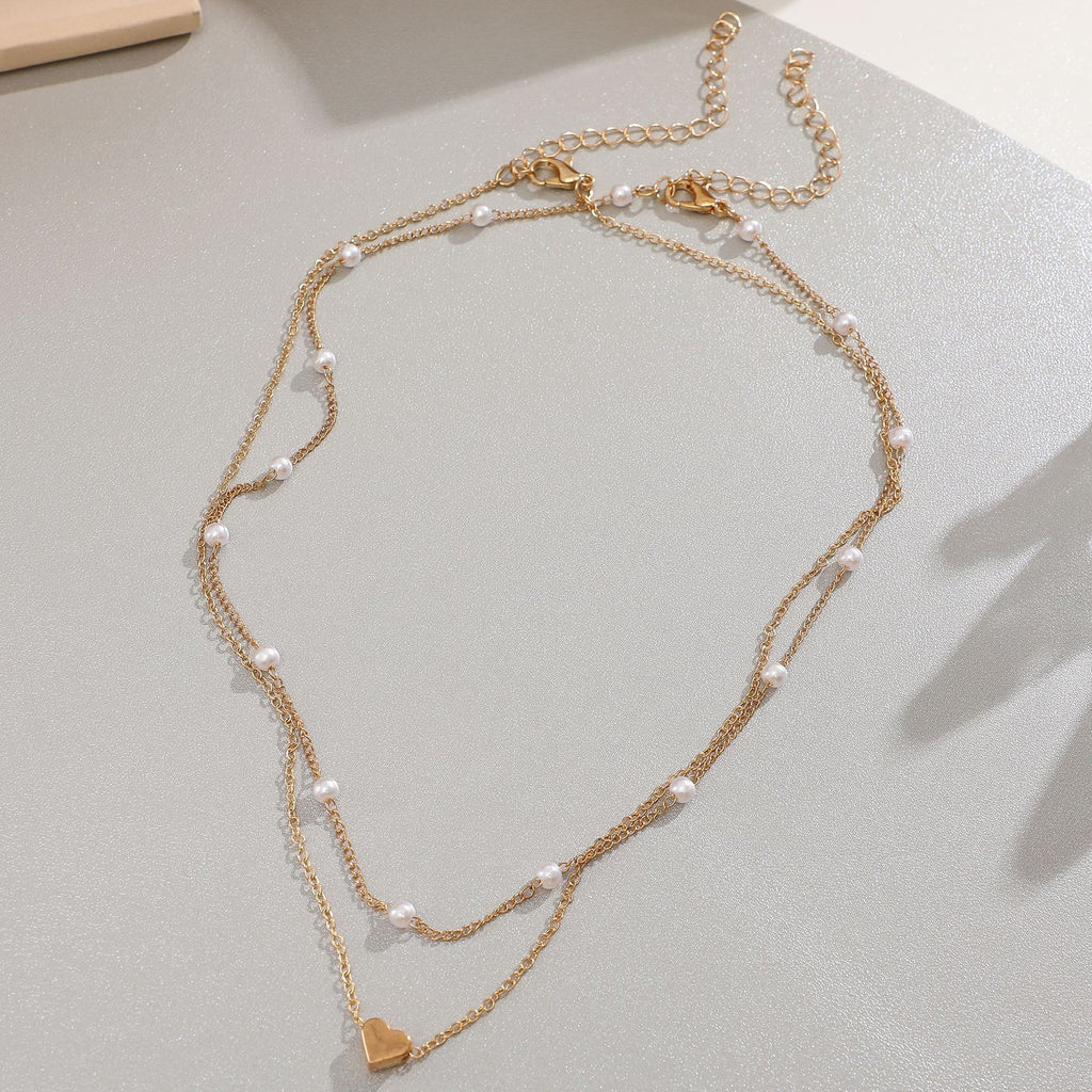 Damen Halskette mit eleganten Perlen und zarten Herzanhängern Shop Nory