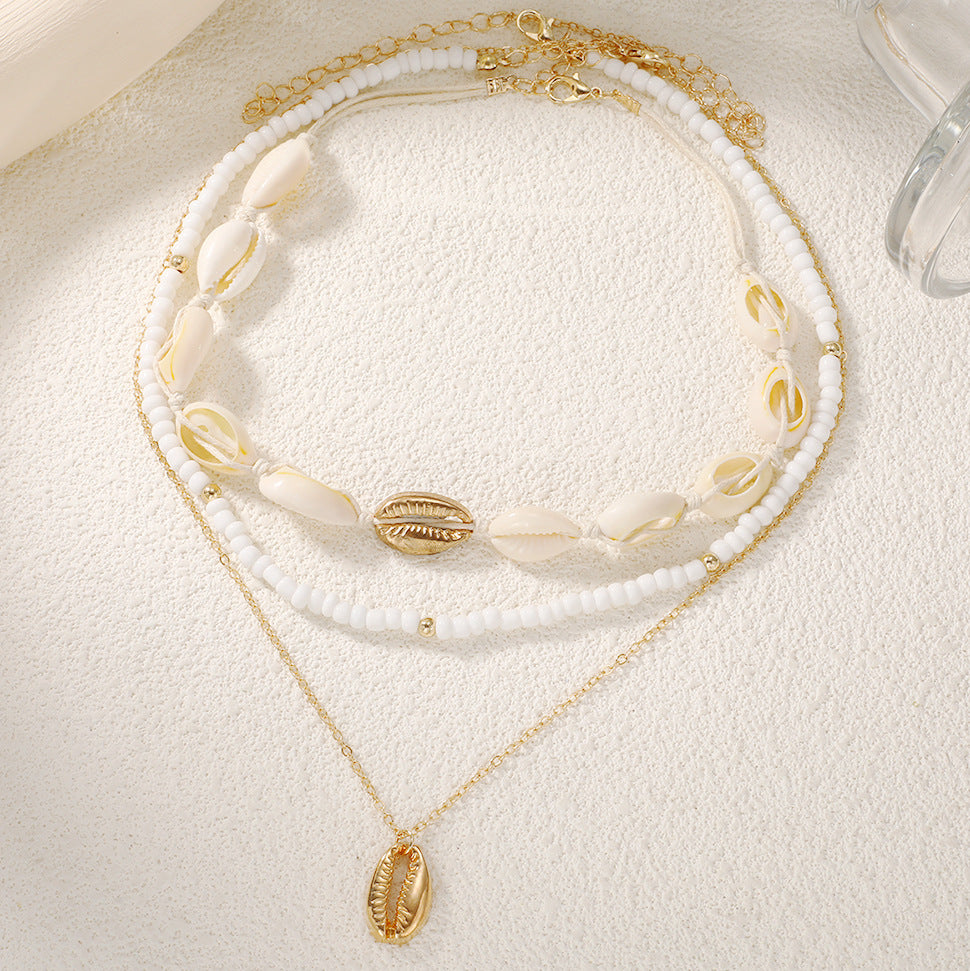 Damen mehrlagige Muschelkette mit goldenen Akzenten Shop Nory