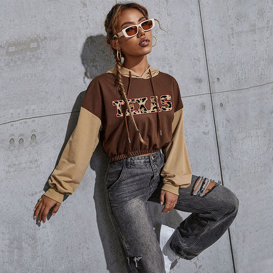 Damen Kurzgeschnittener Kapuzenpullover mit Teddy‑Print, Colorblock‑Ärmeln und elastischem Saum Shop Nory