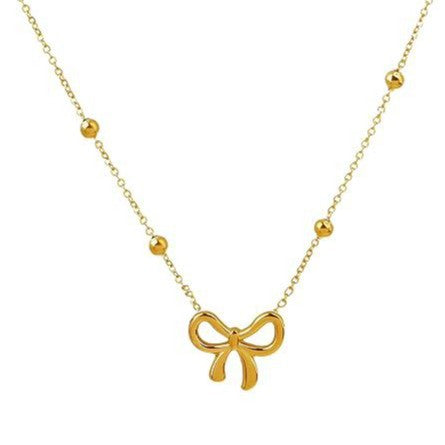 Damen Halskette mit filigranem Schleifenanhänger und glänzenden Kugeldetails Shop Nory
