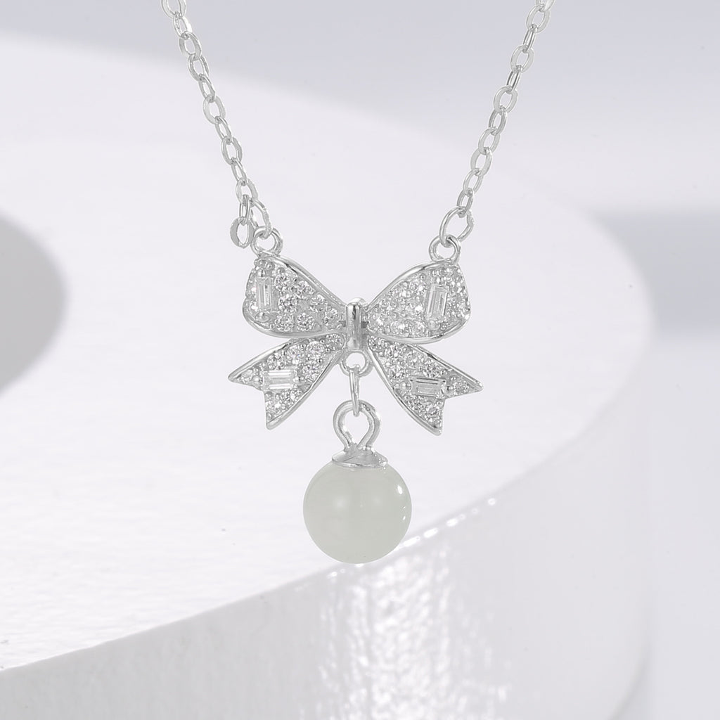 Damen Halskette mit kunstvollem Schleifenanhänger und eleganter Perle Shop Nory