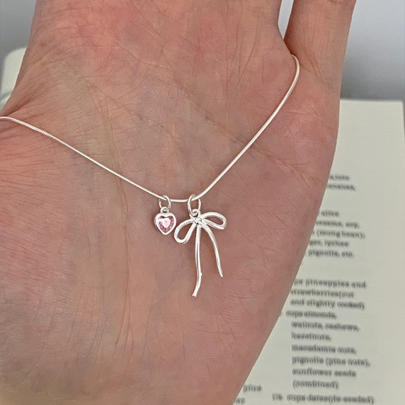 Damen Halskette mit elegantem Schleifenanhänger und herzförmigem Kristall Shop Nory