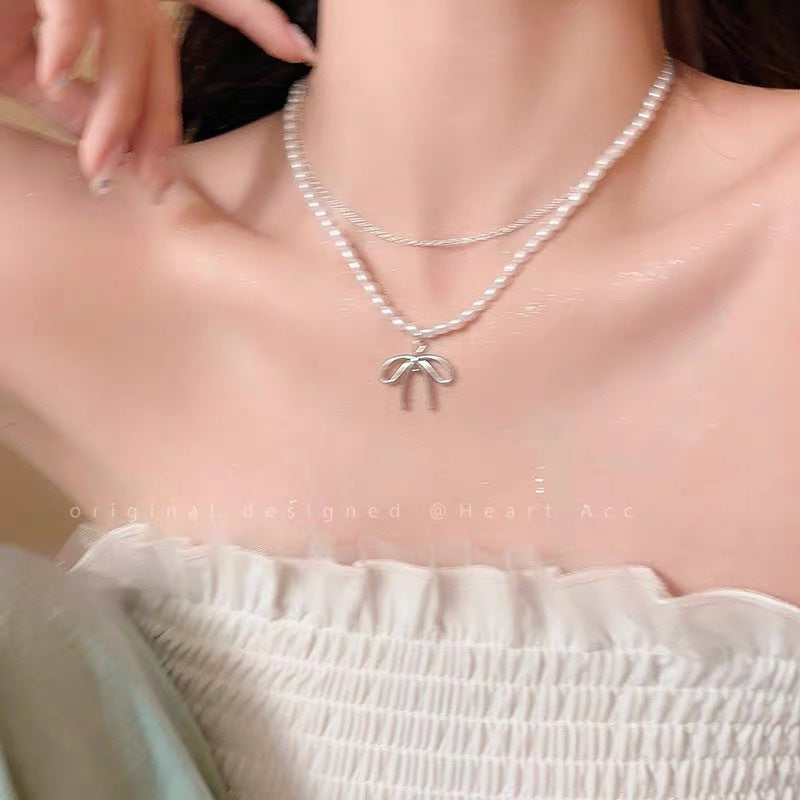 Damen Halskette mit luxuriösen Perlen und filigranem Schleifenanhänger Shop Nory