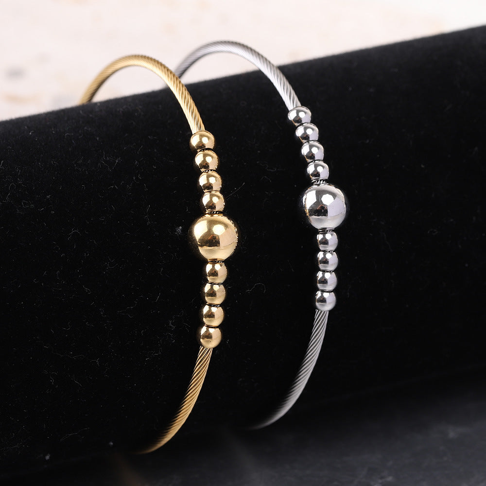 Damen Armreif mit elegantem Drahtdesign und funkelnden Kugeldetails Shop Nory