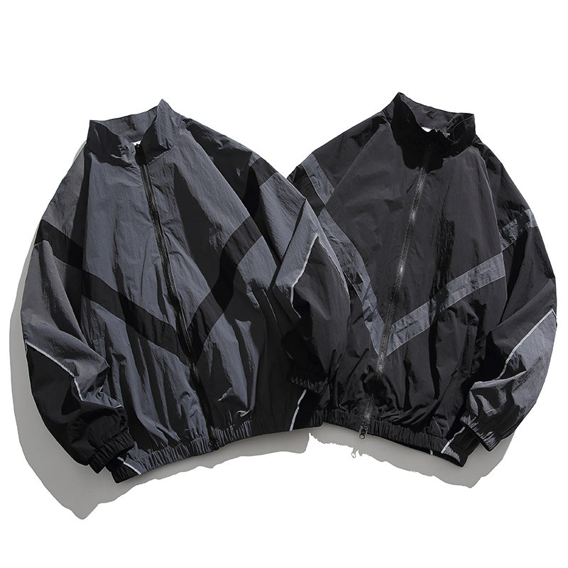 [Unisex] Oversize technische Wind- und Regenjacke mit Stehkragen, reflektierenden Paspeln und elastischem Saum Shop Nory
