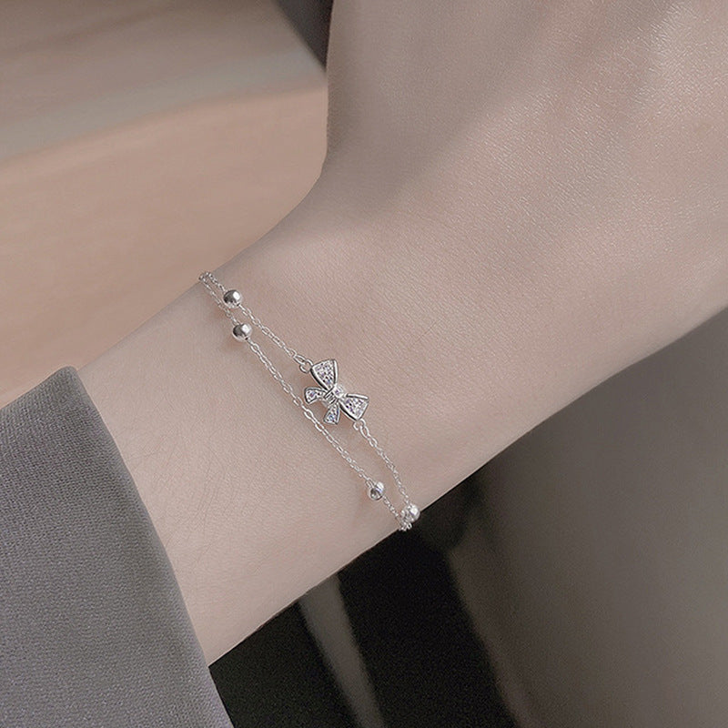 Damen Armband mit zartem Schleifen-Design und funkelnden Kristallen Shop Nory