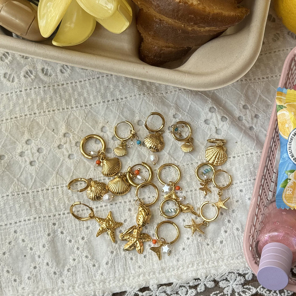 Damen Goldene Ohrringe mit Muschel-Design und Zirkonia Akzenten Shop Nory