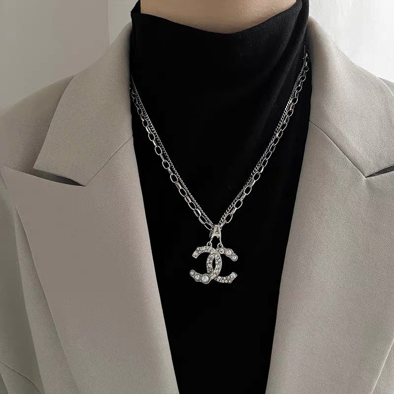 Damen Kette mit funkelndem Logoanhänger und Perlendetails Shop Nory