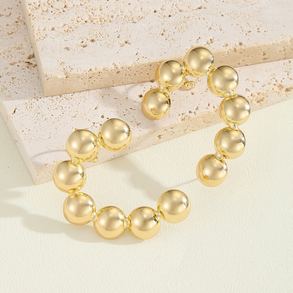 Damen Armband mit strukturierten, goldenen Kugeln Shop Nory
