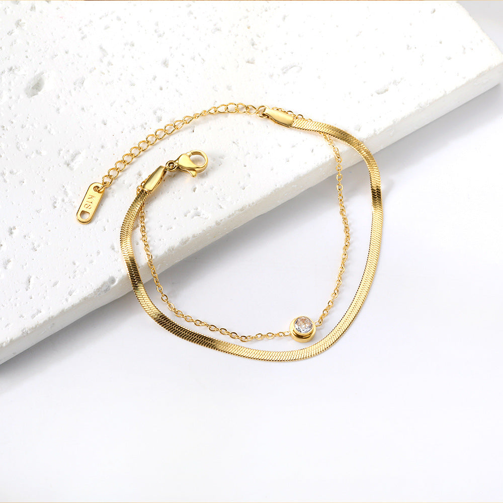 Damen Edelstahl Armband mit funkelndem Zirkonia und goldplattiertem Design Shop Nory