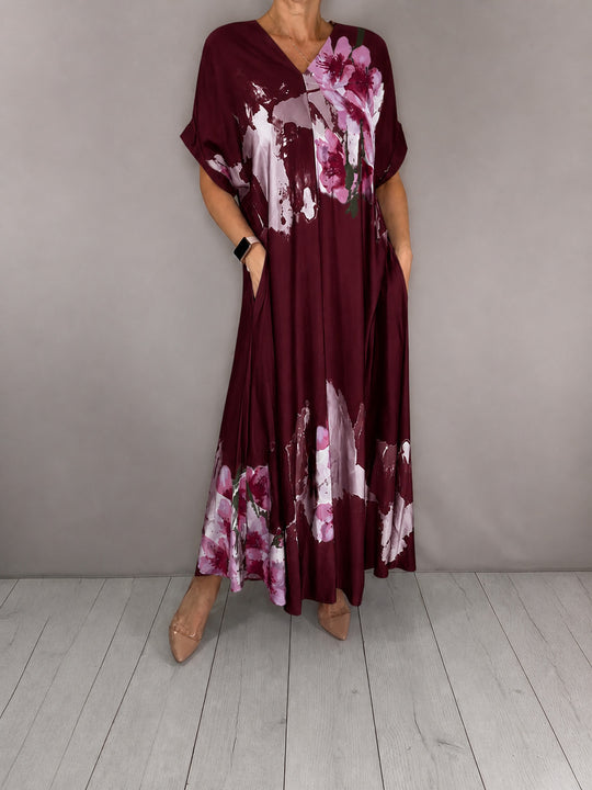Damen Maxikleid mit weitem Fall, V-Ausschnitt, Eingrifftaschen und floraler Aquarelloptik Shop Nory