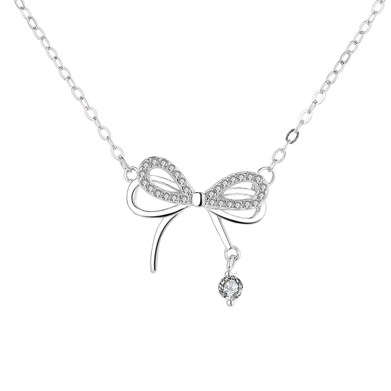 Damen Halskette mit filigranem Schleifenanhänger und funkelndem Zirkon Shop Nory