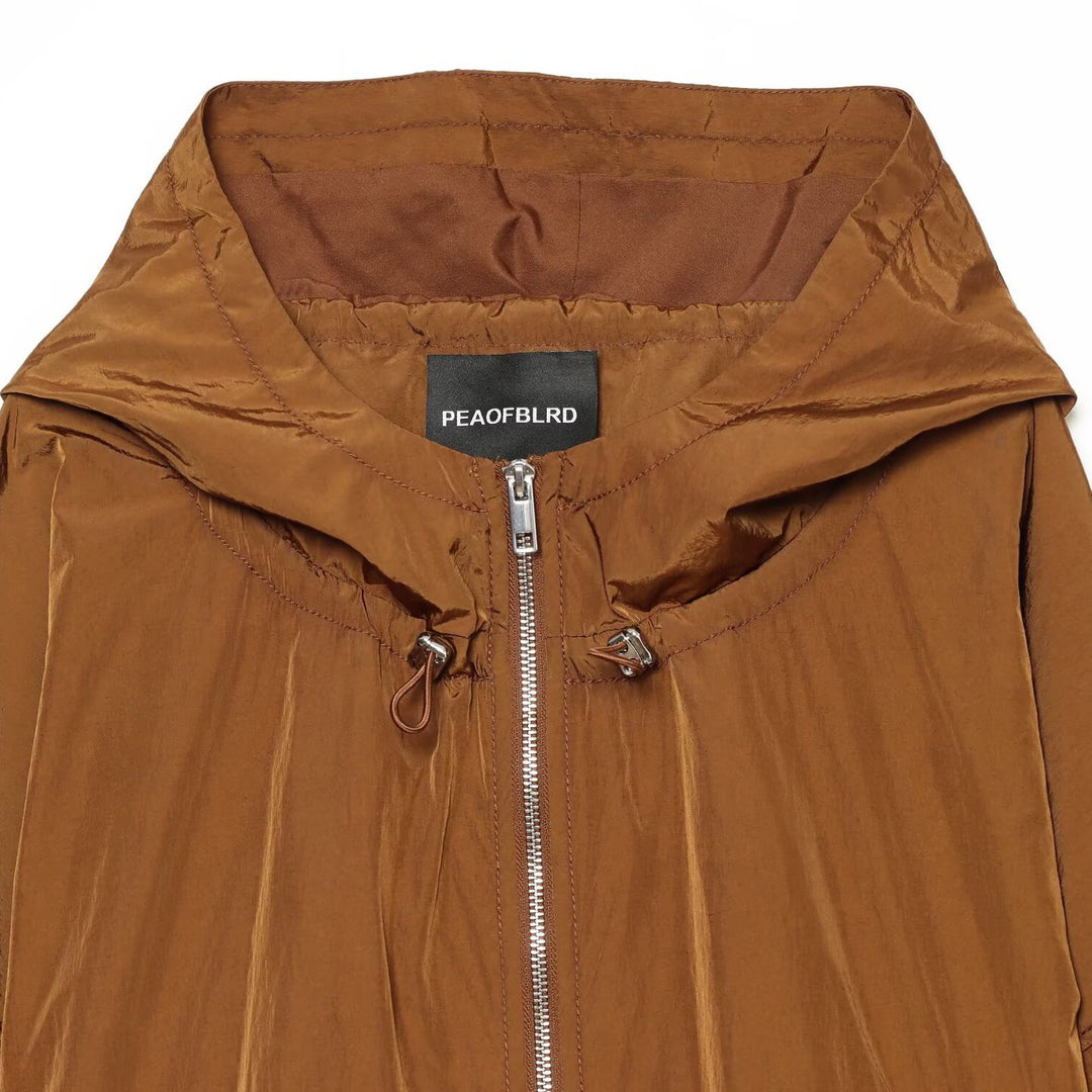 Damen Leichte Kapuzen‑Windjacke aus glänzendem Nylon mit Tunnelzug und Zwei‑Wege‑Reißverschluss Shop Nory