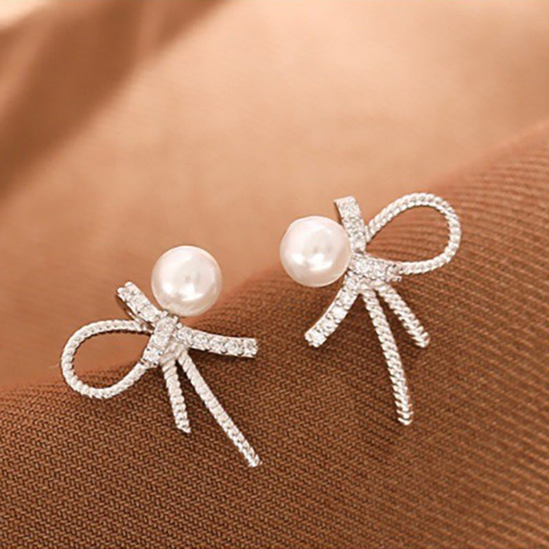 Damen Ohrstecker mit elegantem Schleifen-Design und funkelnden Perlen Shop Nory