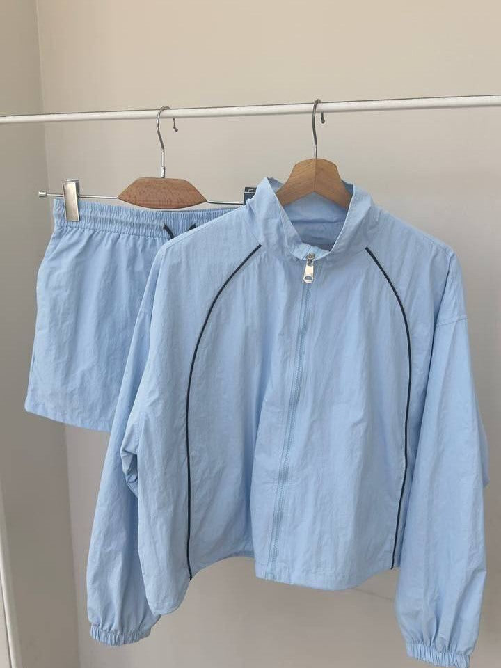 Damen gekürztes Windjacke-Set mit Stehkragen, kontrastierender Paspelierung und elastischer kurzer Freizeit-Hose Shop Nory