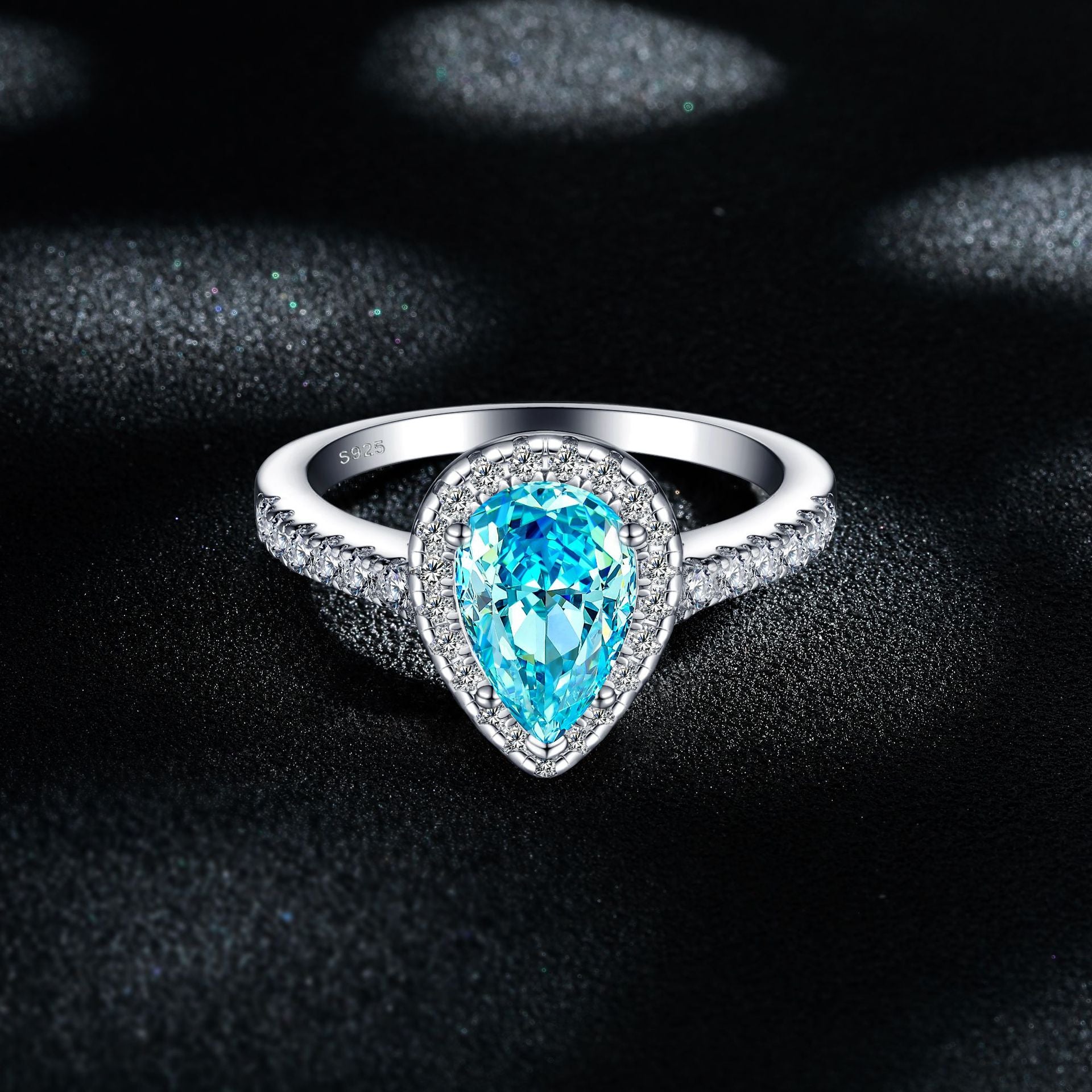 Damen eleganter Tropfenring mit funkelndem aquablauem Hauptstein und Zirkonia-Besatz Shop Nory