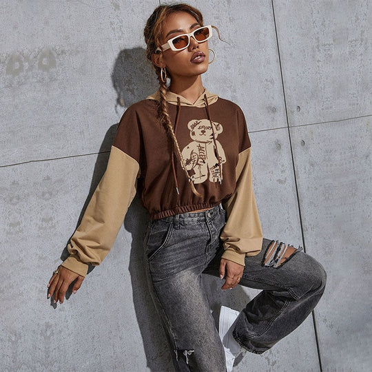 Damen Kurzgeschnittener Kapuzenpullover mit Teddy‑Print, Colorblock‑Ärmeln und elastischem Saum Shop Nory