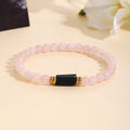 Damenarmband aus Rosenquarz mit schwarzem Akzent und goldenen Verzierungen Shop Nory