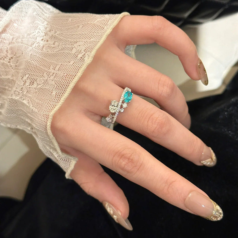Damenring mit funkelnden Zirkonia und elegantem Türkisakzent Shop Nory