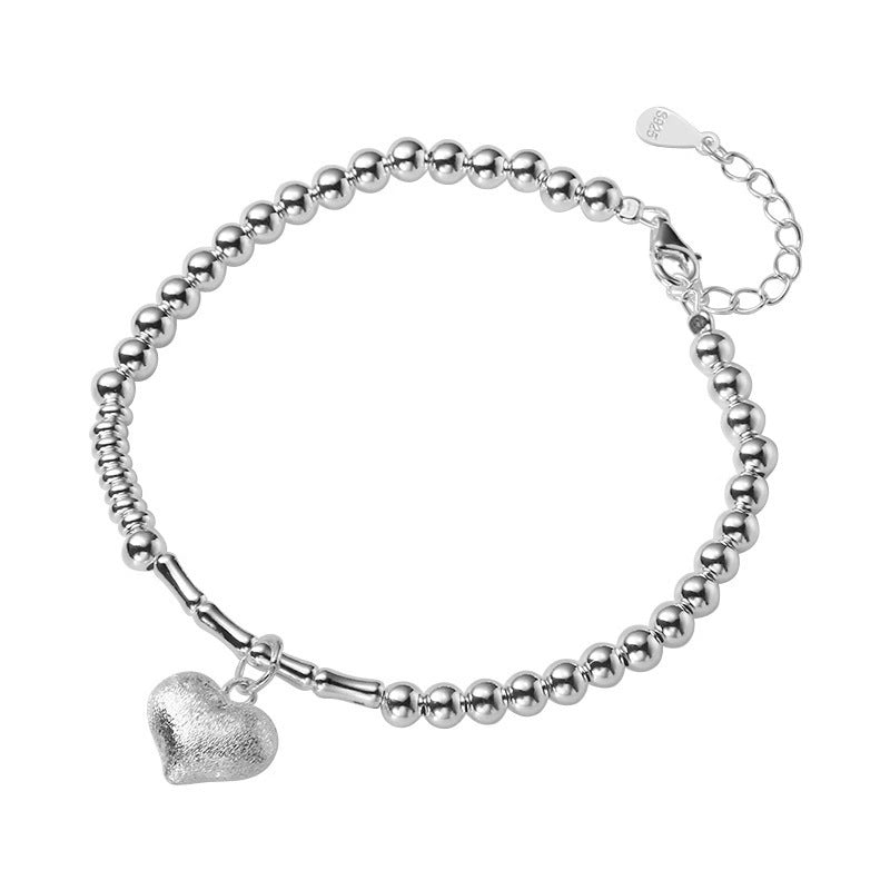 Damen Armkette mit charmantem Herzanhänger und eleganten Perlendetails Shop Nory