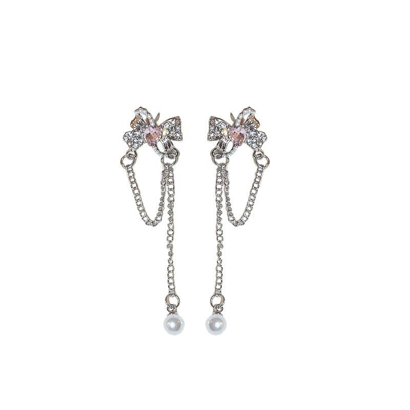Damen Ohrringe mit filigranem Schleifen-Design und funkelnden Perlendetails Shop Nory