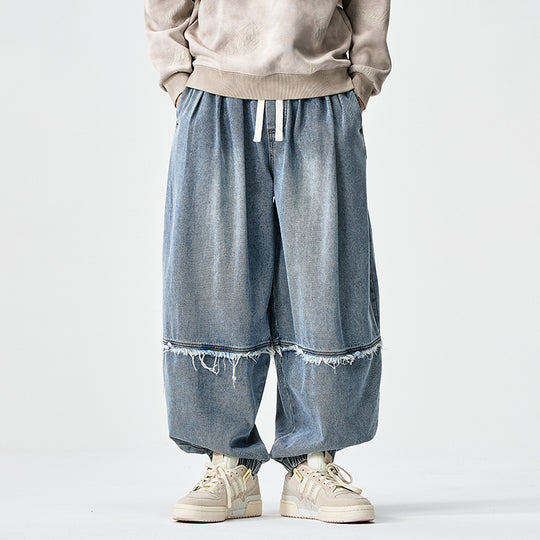 Herren Weit geschnittene Baggy-Denim-Hose mit Tunnelzug, elastischen Beinabschlüssen und Fransen-Detail Shop Nory