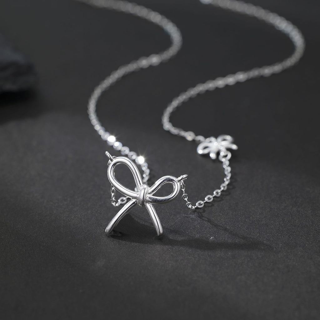 Damen Halskette mit kunstvollem Schleifenanhänger und feiner Gliederkette Shop Nory