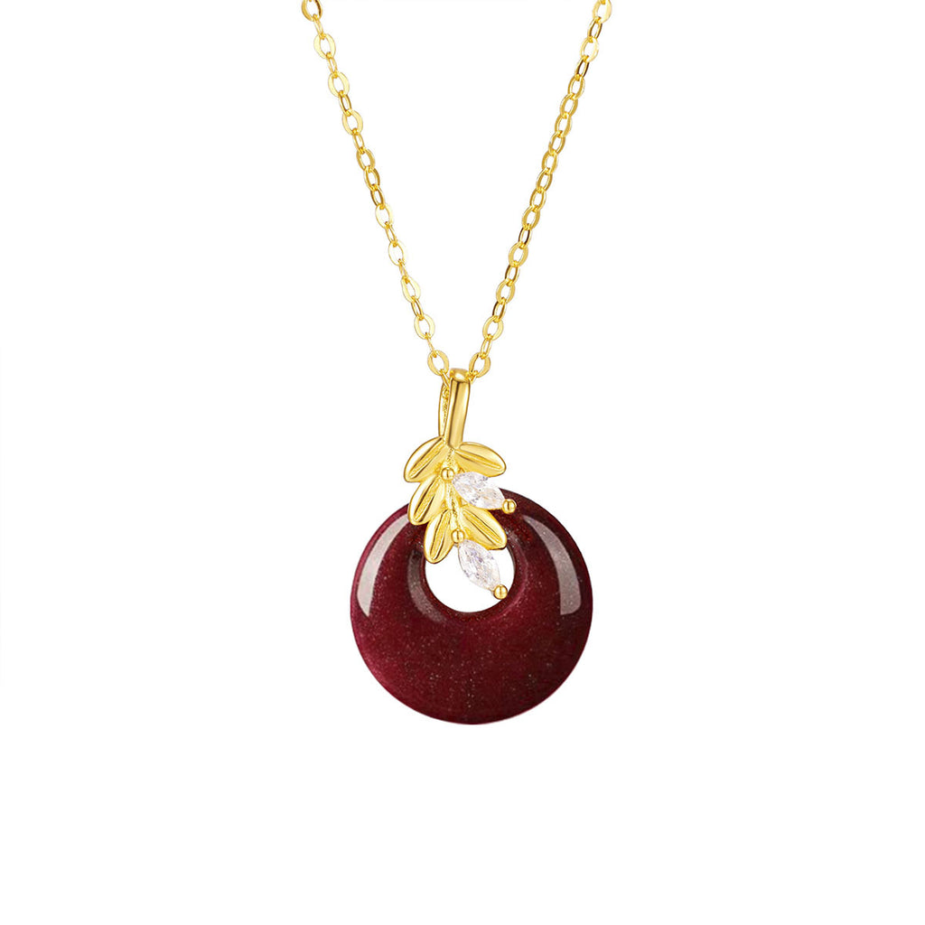 Damen Halskette mit kunstvollem runden Anhänger aus rotem Halbedelstein und goldenen Blätterdetails Shop Nory