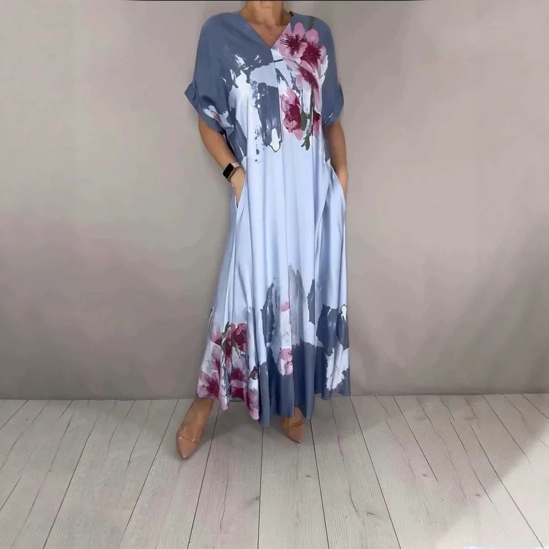 Damen Maxikleid mit weitem Fall, V-Ausschnitt, Eingrifftaschen und floraler Aquarelloptik Shop Nory