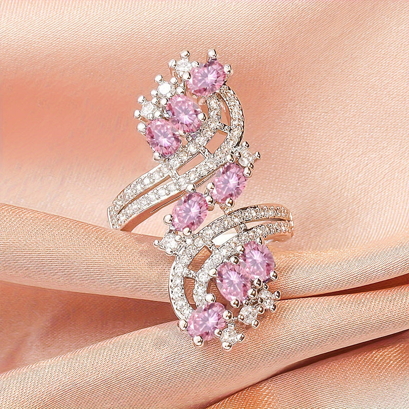 Damenring mit kunstvollem Wellenmuster und eleganten rosa Kristallen Shop Nory