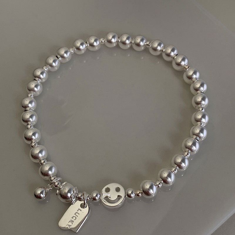 Damen Armreif mit verspieltem Smiley-Anhänger und Perlen Shop Nory
