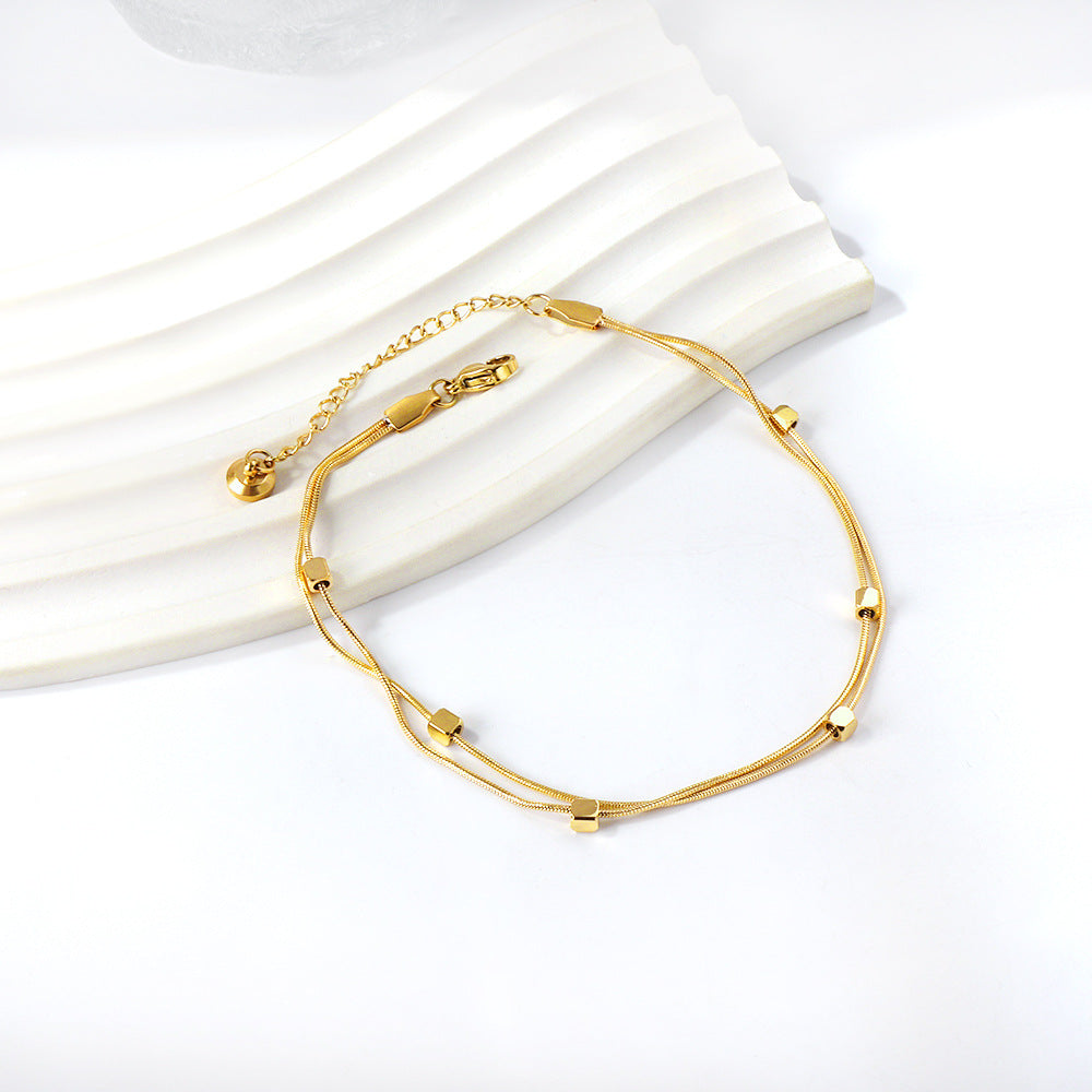Damen Armband mit floralen Anhängern aus goldplattiertem Edelstahl Shop Nory